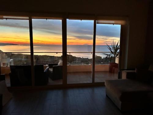 a room with a large window with a view of the ocean at ZAMBRONE VILLAGE Loris in Zambrone