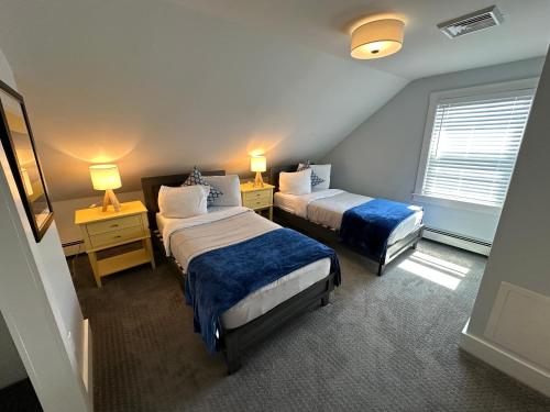a room with two beds and two tables and two lamps at 86 Dr Marcus House - Popular Broadway Area in Newport