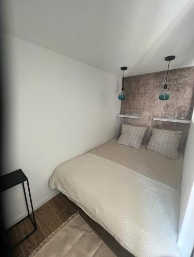 - une chambre dotée d'un lit avec deux lumières dans l'établissement Studio indépendant et équipé proche Circuit des 24h et Pôle Européen du Cheval, à Parence