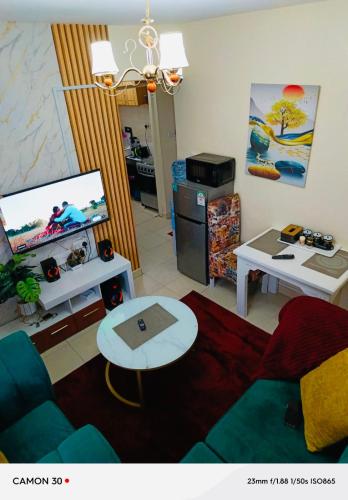 a living room with a couch and a tv at ONE BEDROOMS THIKA ROAD ,TRM DRIVE Homes by Essyruby in Nairobi