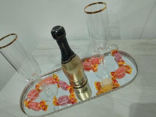 a bottle of champagne and glasses on a table at Dodi's house in Pozzuoli