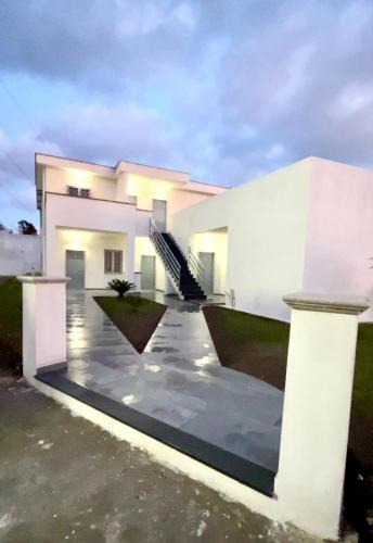 a large white house with a driveway at Dodi's house in Pozzuoli