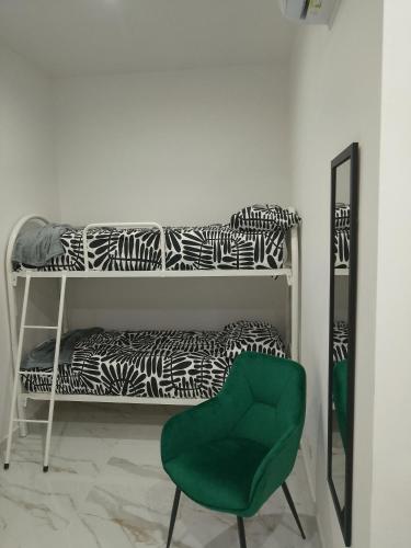 a green chair sitting in front of a mirror at Dodi's house in Pozzuoli