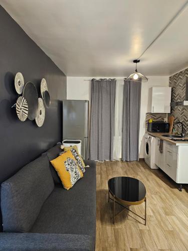 un salon avec un canapé et une cuisine dans l'établissement Apt at stlazarre opera haussman, à Paris