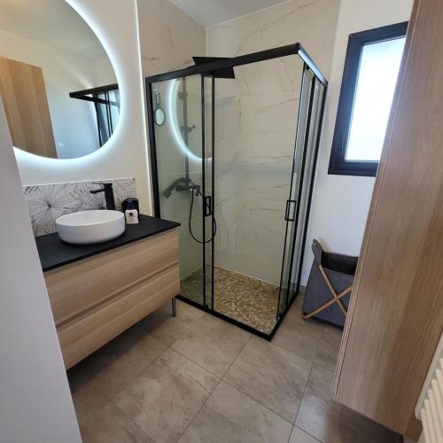 une salle de bain avec une douche avec un lavabo et un miroir dans l'établissement Pavillon neuf CREANCES plage, à Créances