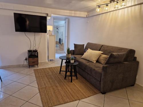 a living room with a couch and a table at Le Cosy - Place Masséna in Nice