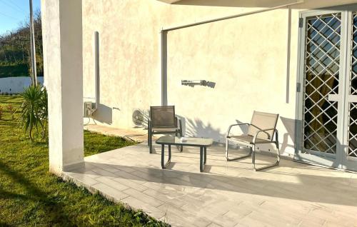 two chairs and a table on a patio at Dodi's house in Pozzuoli