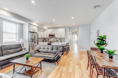 a living room with a couch and a table at Furnished Apartment Near Logan Airport in Boston