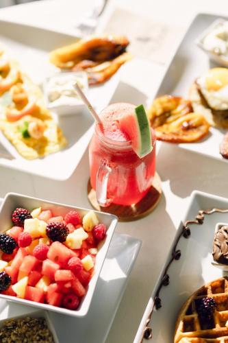 a table topped with plates of pastries and a drink at Ka´ana Surf in El Paredón Buena Vista