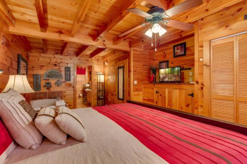 a bedroom with a large bed in a log cabin at Thistle Britches, Secluded Mountain Cabin with Stunning Mountain Views, 1 Acre Next to Dollywood, Hot Tub, Pet Friendly in Sevierville