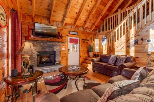 a living room with a couch and a fireplace at Thistle Britches, Secluded Mountain Cabin with Stunning Mountain Views, 1 Acre Next to Dollywood, Hot Tub, Pet Friendly in Sevierville