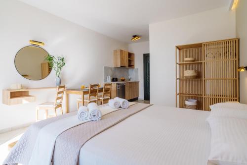 a bedroom with a large white bed with towels on it at Eagle's Nest in Lourdhata