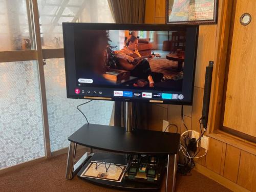 a flat screen tv sitting on a stand at アウトドアアトラクション北軽井沢 in Tsumagoi