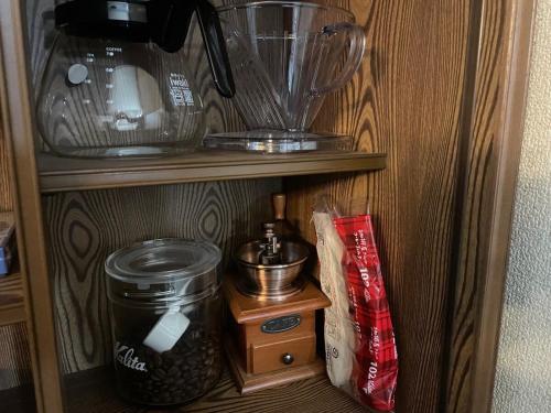 a wooden shelf with a blender and other items on it at アウトドアアトラクション北軽井沢 in Tsumagoi