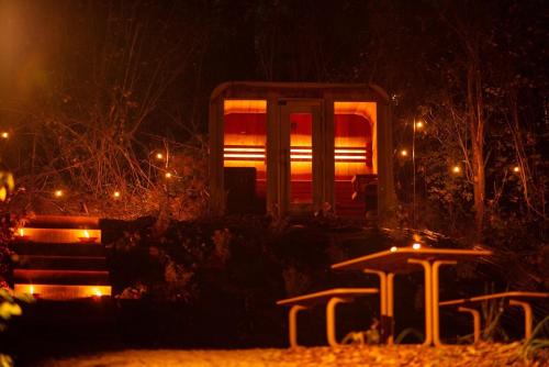 a train car at night with lights on at Inarden Yellowstone Cabin in Durbuy