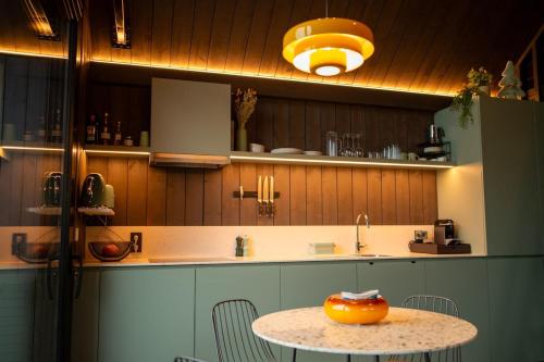 a kitchen with a table with a bowl on it at Inarden Yellowstone Cabin in Durbuy