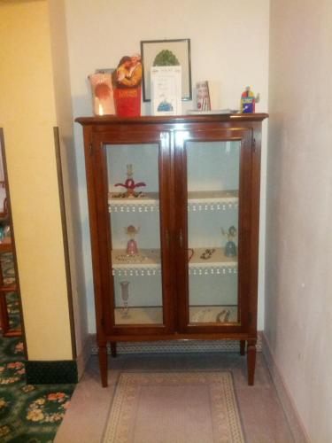 a wooden cabinet with glass doors in a room at Hotel Villa Tiziana in Venice-Lido