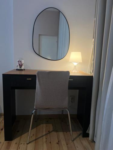 a desk with a chair and a mirror at Florence family 2BDR Apt - min from Serdika w WiFi in Sofia