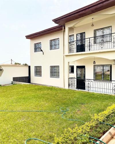 a house with a lawn in front of it at Luma in Yaoundé