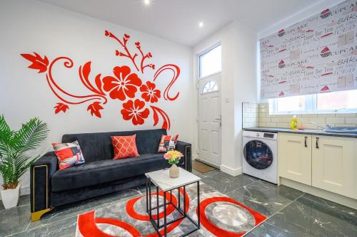 a living room with a couch and a kitchen at -75ACR- Setup for your relaxed & amazing stay in Leeds