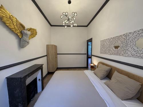 a bedroom with a bed and a fireplace at Suite Marguerite - Haussmannien chic hyper centre in Angers