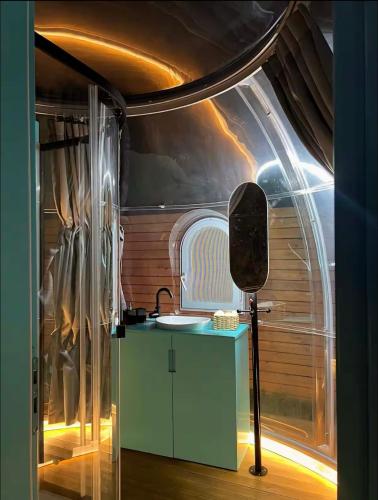 a bathroom with a sink in a room with a ceiling at Sial Skynest in Vlorë