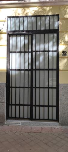 a door with a metal gate on the side of a building at Apartamento Centro Madrid Atocha in Madrid
