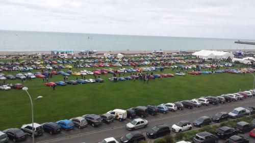 a parking lot with many cars parked next to the beach at Hôtel Windsor Contact Hôtel in Dieppe
