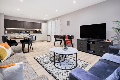 a living room with a couch and a flat screen tv at Birmingham Gem 2-Bed with Netflix, Fun & Parking in Birmingham