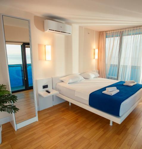 a bedroom with a large bed and a large mirror at Luxury apartments in city center in Batumi