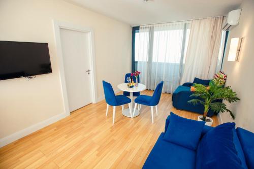 a living room with a blue couch and a table at Luxury apartments in city center in Batumi