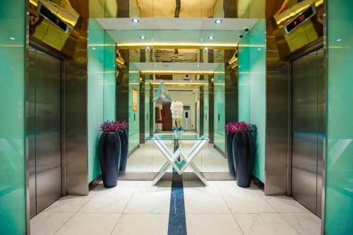 a view of a hallway with vases in a building at Luxury apartments in city center in Batumi