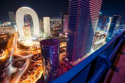 a view of a city at night with buildings at Luxury apartments in city center in Batumi