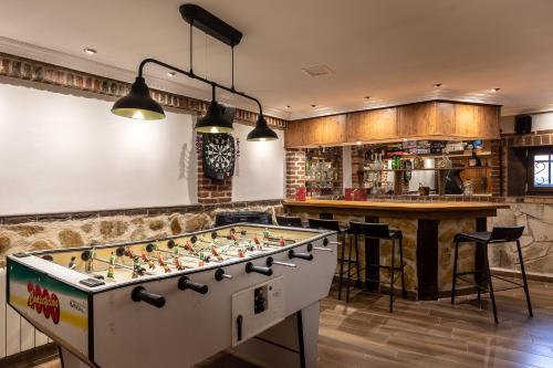 a kitchen with a pool table and a bar at Villa Pepe Paz y Encanto Natural in Villarán