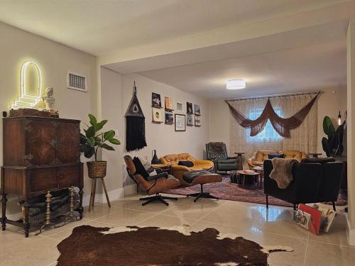 a living room with a couch and chairs in it at -Disco Bungalow- One third mile to FTL Marine Center in Fort Lauderdale