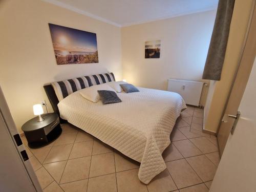 Postel nebo postele na pokoji v ubytování Ferienwohnung - Frische Brise 04 01