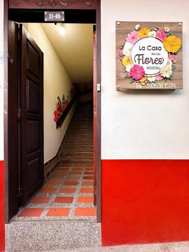 a door to a building with a no cats on floors sign at La Casa de las Flores Hostal in Jardin