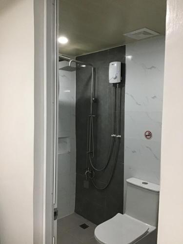 a bathroom with a shower and a toilet at Agateahs Place mini beach resort in Olongapo
