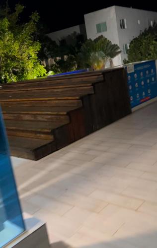 a garden with a retaining wall and a wooden fence at Best ocean view Sosua-Cabarete in Sosúa