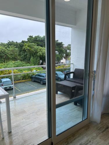 a sliding glass door with a view of a balcony at Best ocean view Sosua-Cabarete in Sosúa