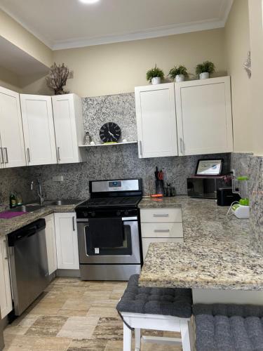 a kitchen with white cabinets and a stove at Best ocean view Sosua-Cabarete in Sosúa