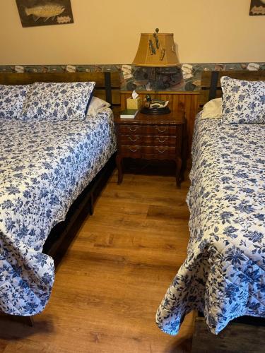 a bedroom with two beds and a table with a lamp at Mountain Aire Cottages, Inn, & Glamping in Clayton