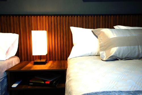 a bedroom with a bed and a night stand with a lamp at Departamento Nuevo Centro Monterrey in Monterrey