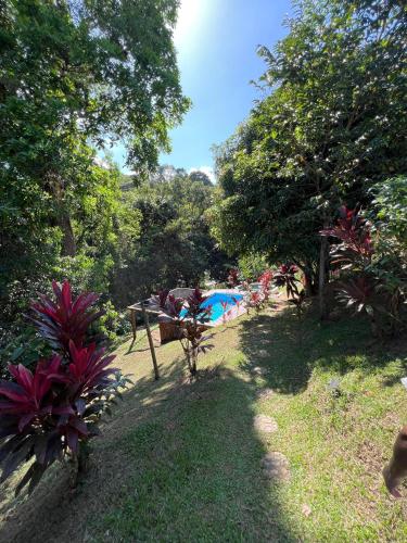 a garden with trees and a field of grass at Sweet Harmony Hotel Boutique by Xarm Hotels in Minca