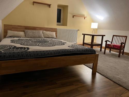 a bedroom with a large bed and a chair at Kirchhof in Dobis