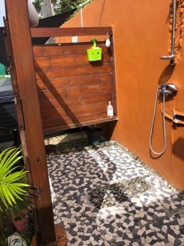 a bathroom with a tiled floor with a shower and a shower at PASSION de PARADIS in Rivière-Pilote