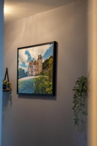 a picture of a castle hanging on a wall at Luxury 5-Bed Penthouse with Free Parking & Views in Belfast