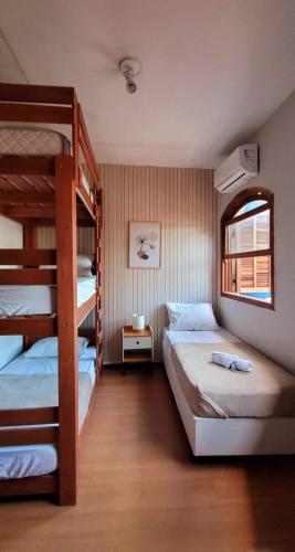 a bedroom with two bunk beds and a window at Matianellu SP in São Paulo