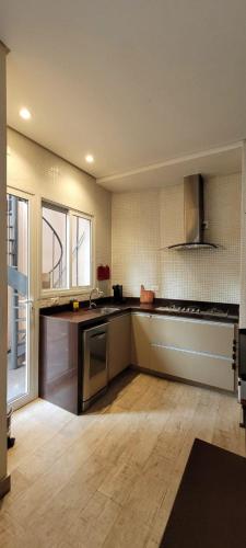 a kitchen with a sink and a counter top at Matianellu SP in São Paulo