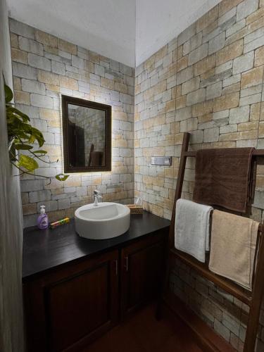 a bathroom with a sink and a mirror at Nivartana Villa and Purana Ayurveda Center in Bentota